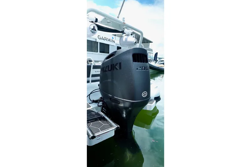 Slide: The Image of Outboard motor on 2025 Highfield Sport 660 boat, docked with Garmin equipment. - 6