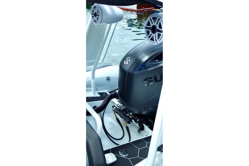 Slide: The Image of 2025 Highfield Sport 660 boat engine and speaker detail on water. - 7