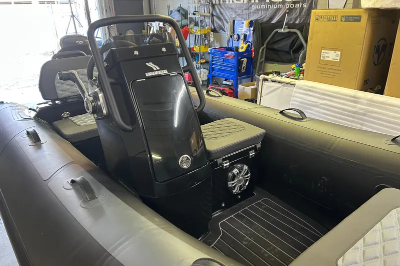 Slide: The Image of 2025 Highfield Sport 360 inflatable boat interior with steering console and seating. - 3