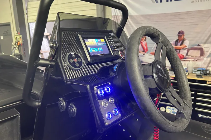 Slide: The Image of 2025 Highfield Sport 360 boat dashboard with steering wheel and digital display. - 12