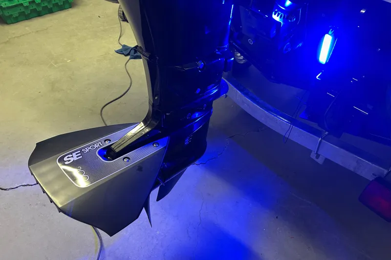 Slide: The Image of Outboard motor with SE Sport hydrofoil on Highfield Sport 360, 2025 model, illuminated in blue light. - 15