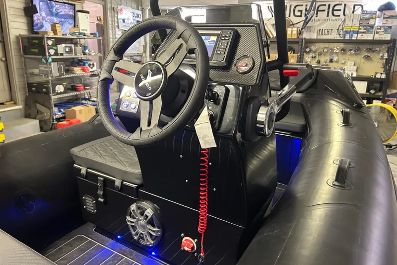 Slide: The Image of Interior of 2025 Highfield Sport 360 boat with steering wheel and control panel. - 18