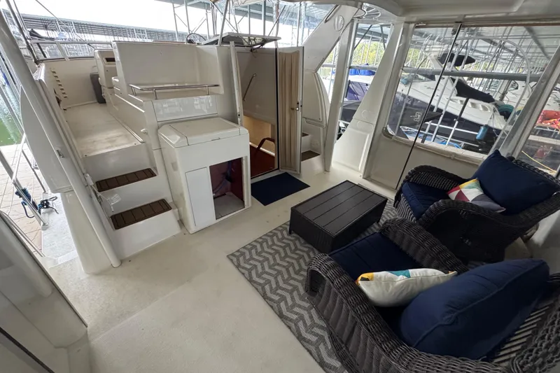 Slide: The Image of 2000 Carver 406 Aft Cabin Motor Yacht interior with seating area and stairs. - 10