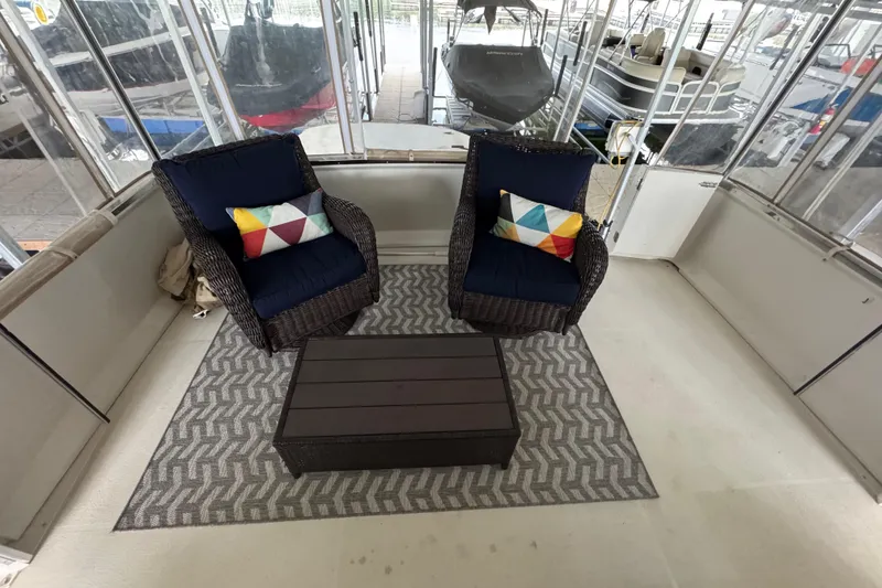 Slide: The Image of 2000 Carver 406 Aft Cabin Motor Yacht interior with cozy seating and colorful cushions. - 11