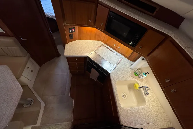 Slide: The Image of Interior of 2000 Carver 406 Aft Cabin Motor Yacht kitchen with sink and microwave. - 19
