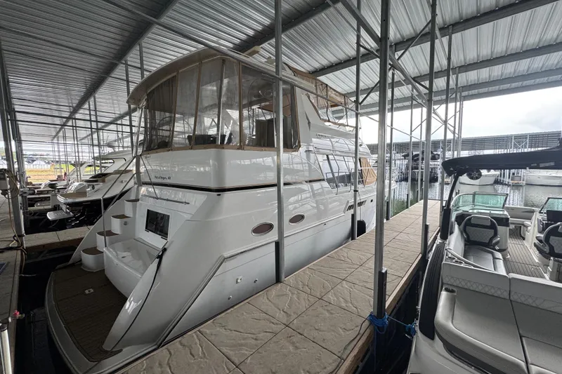 Slide: The Image of 2000 Carver 406 Aft Cabin Motor Yacht docked in a covered marina. - 5