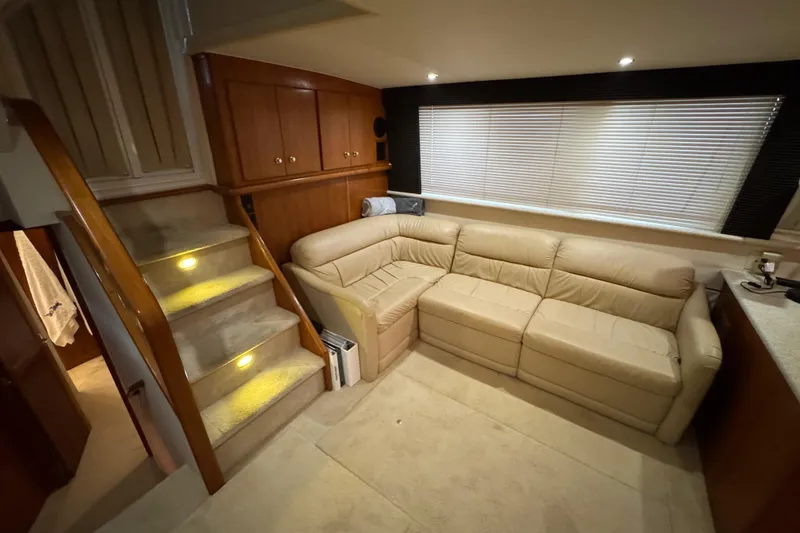 Slide: The Image of Interior of 2000 Carver 406 Aft Cabin Motor Yacht with beige leather sofa and carpeted stairs. - 18