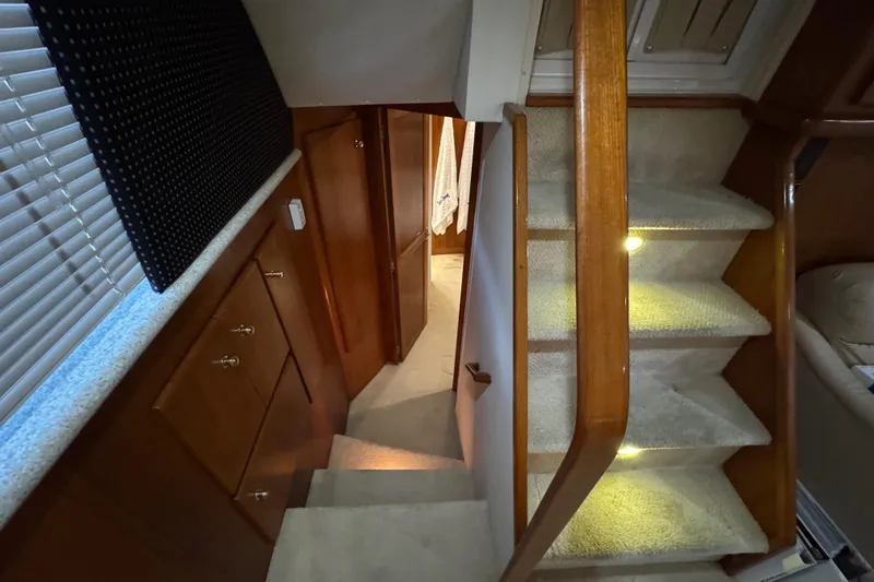 Slide: The Image of Interior of 2000 Carver 406 Aft Cabin Motor Yacht with carpeted stairs and wooden cabinetry. - 21