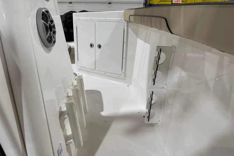 Slide: The Image of 2022 Yamaha Boats 255 FSH Sport E interior with storage compartments and rod holders. - 10