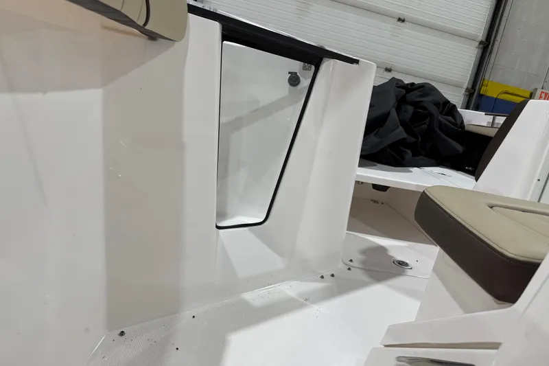 Slide: The Image of 2022 Yamaha Boats 255 FSH Sport E interior with seating and storage compartment. - 11