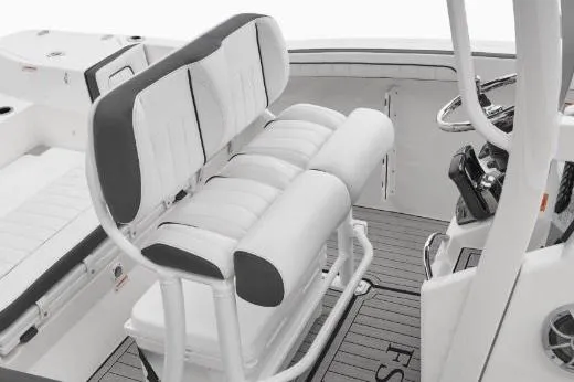 Slide: The Image of 2022 Yamaha Boats 255 FSH Sport E interior with cushioned seating and steering console. - 15