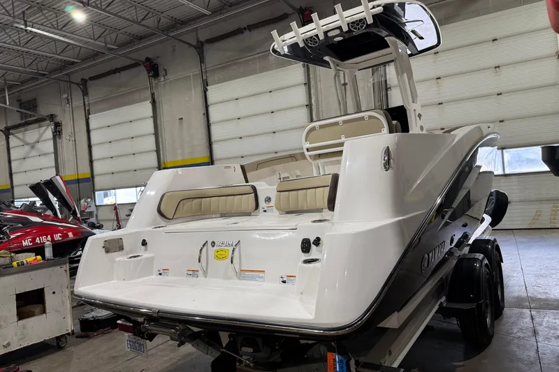 Slide: The Image of 2022 Yamaha Boats 255 FSH Sport E in a garage, showcasing sleek design and modern features. - 2