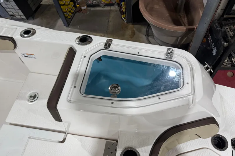 Slide: The Image of 2022 Yamaha Boats 255 FSH Sport E deck with storage compartment and seating. - 4