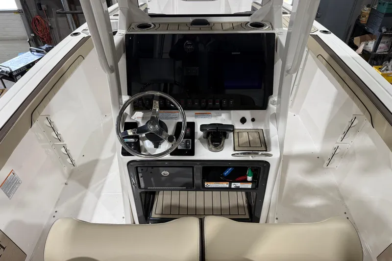 Slide: The Image of 2022 Yamaha Boats 255 FSH Sport E dashboard with steering wheel and controls. - 5