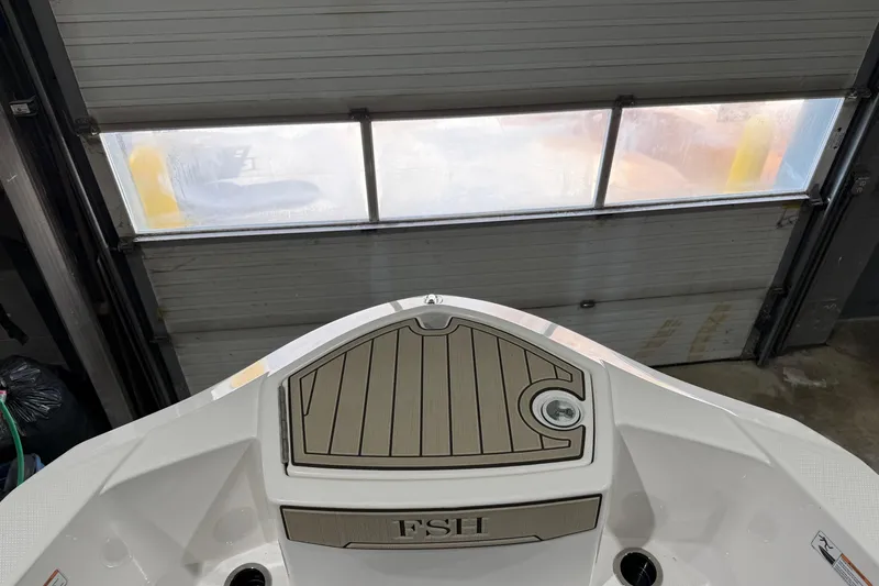 Slide: The Image of 2022 Yamaha Boats 255 FSH Sport E bow in a garage setting. - 8