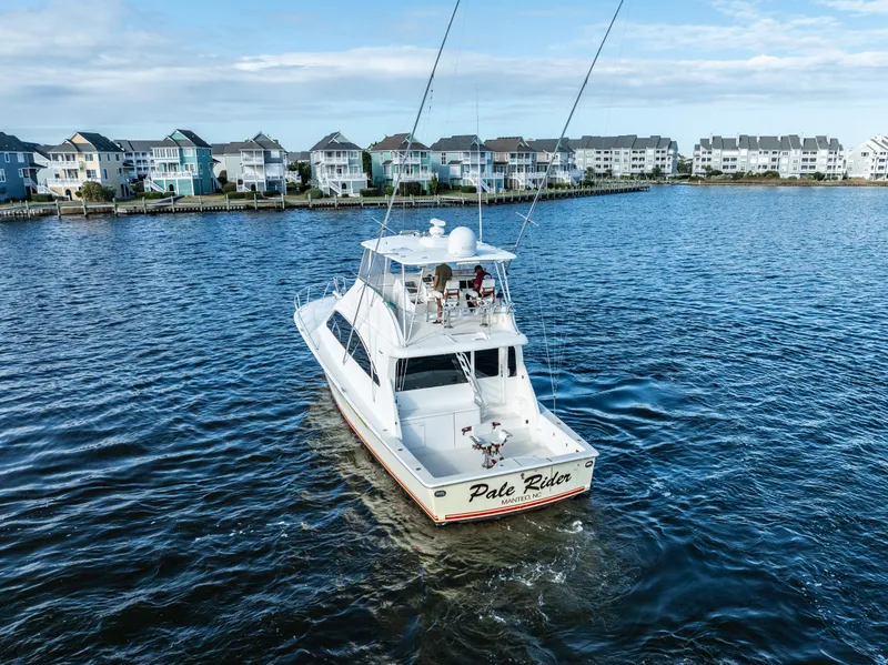 Slide: The Image of Luxury Ocean 57 yacht cruising near coastal homes, 2006 model. - 10