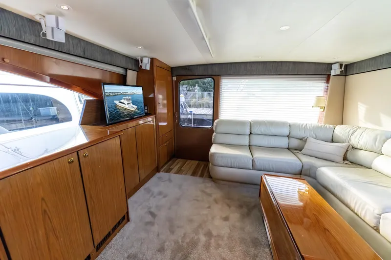 Slide: The Image of Luxurious 2006 Ocean 57 yacht interior with plush seating and wooden cabinetry. - 13
