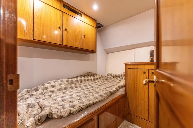Slide: The Image of Cozy cabin interior of 2006 Ocean 57 yacht with wooden cabinets and bed. - 19
