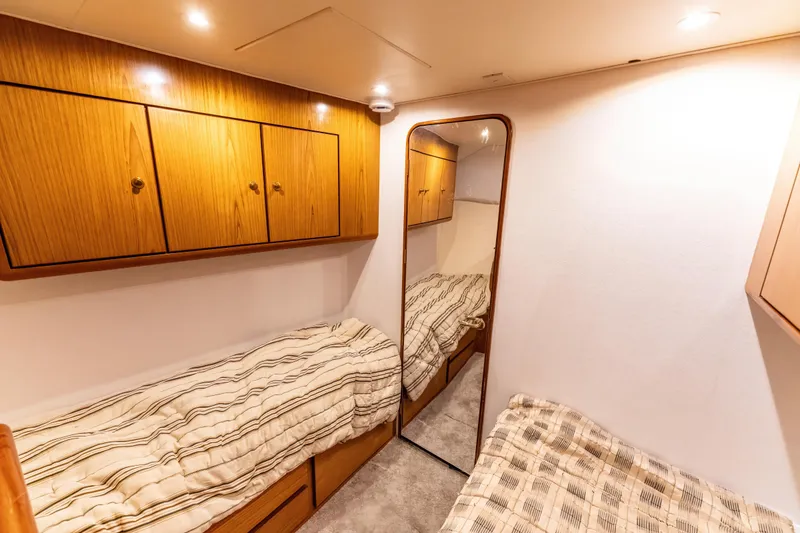 Slide: The Image of Cozy cabin interior of 2006 Ocean 57 yacht with twin beds and wooden cabinets. - 20