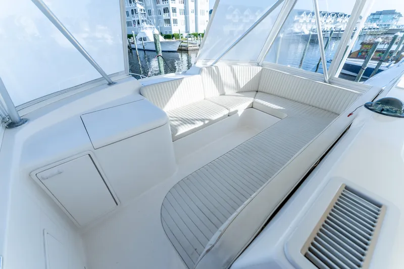 Slide: The Image of Luxurious seating area on a 2006 Ocean 57 yacht, docked at a marina. - 46
