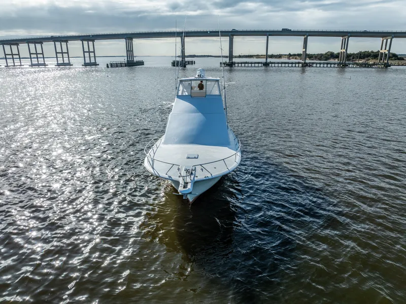 Slide: The Image of Ocean 57 yacht from 2006 on a calm river near a bridge. - 5