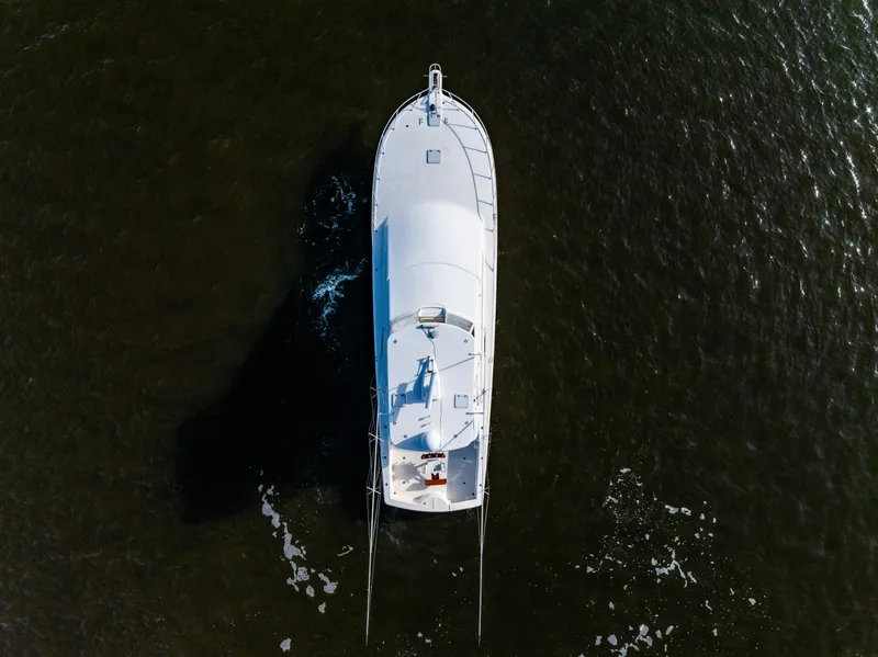 Slide: The Image of Aerial view of 2006 Ocean 57 yacht cruising on dark water. - 7