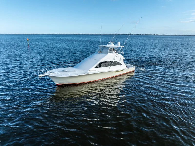 Slide: The Image of 2006 Ocean 57 yacht on calm blue waters under clear sky. - 8