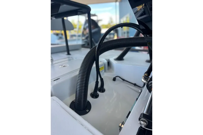 Slide: The Image of 2026 Chittum Skiffs 21 Islamorada boat interior with visible wiring and components. - 13