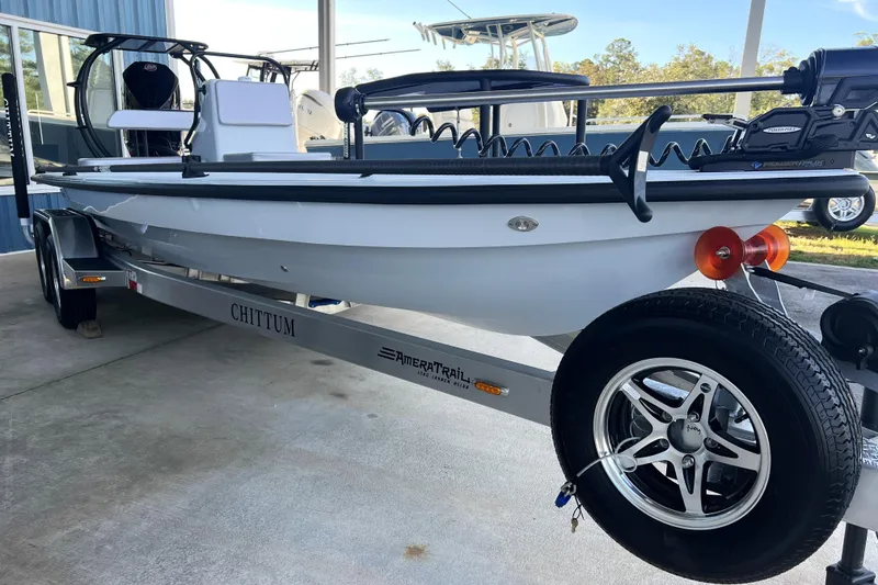 Slide: The Image of 2026 Chittum Skiffs 21 Islamorada boat on trailer, parked outdoors. - 3