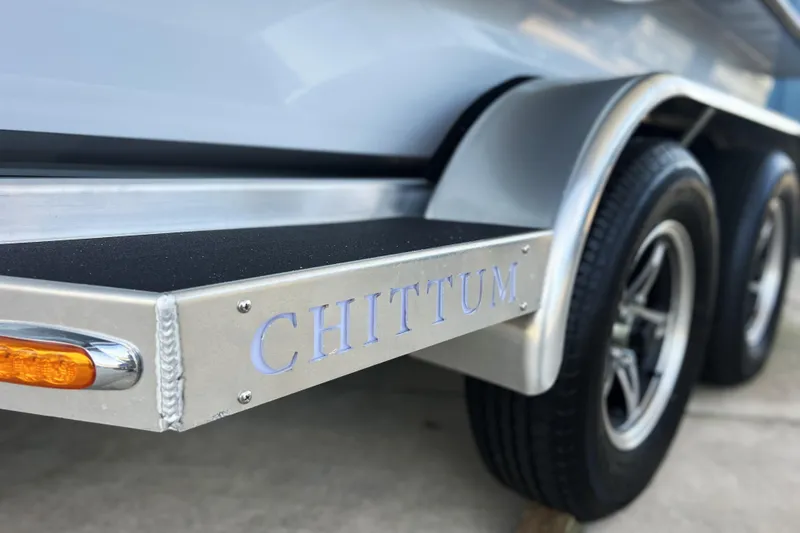 Slide: The Image of 2026 Chittum Skiffs 21 Islamorada trailer detail with logo and wheels. - 9