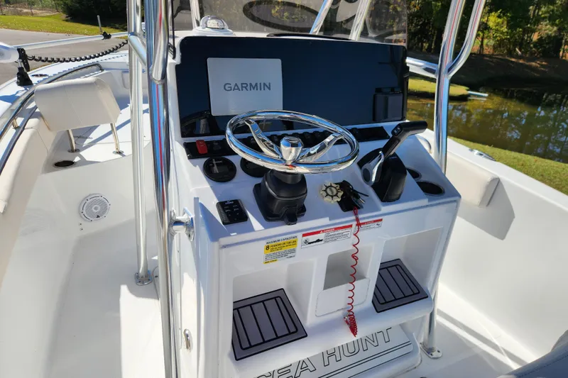 Slide: The Image of 2024 Sea Hunt Ultra 229 boat console with Garmin navigation system and steering wheel. - 10