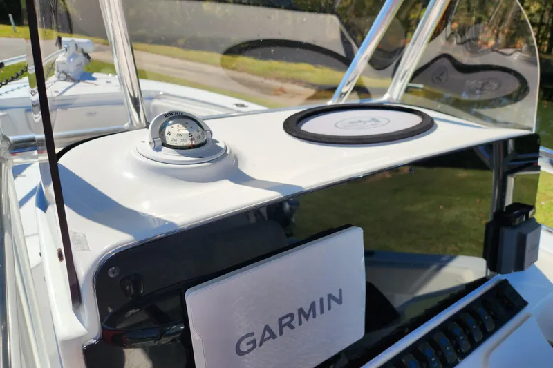 Slide: The Image of 2024 Sea Hunt Ultra 229 dashboard with Garmin navigation and compass. - 11