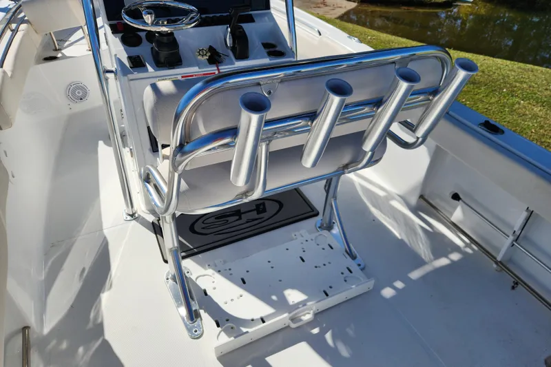 Slide: The Image of 2024 Sea Hunt Ultra 229 boat interior with rod holders and steering console. - 14