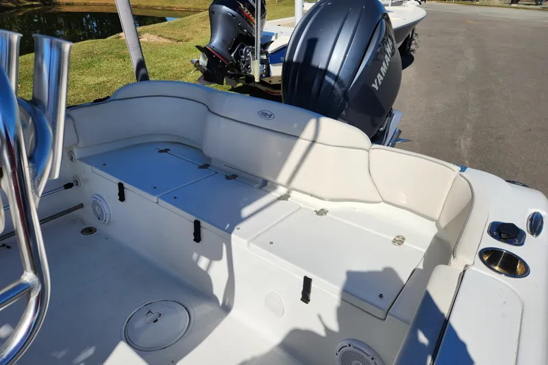 Slide: The Image of 2024 Sea Hunt Ultra 229 boat interior with Yamaha engine, featuring seating and storage. - 15
