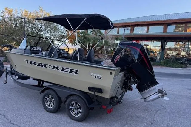 Slide: The Image of 2026 Tracker Targa V-19 Combo boat on trailer with canopy and outboard motor. - 2
