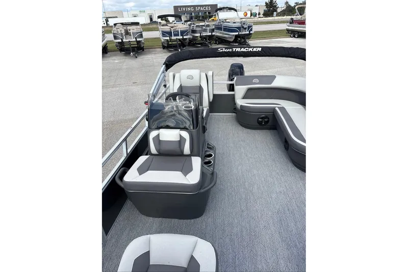 Slide: The Image of 2026 Sun Tracker Bass Buggy 16 XL Select pontoon boat interior with seating and console. - 5