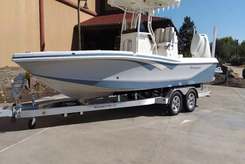 The Image of 2026 Ranger 2600 Bay boat on trailer, parked outdoors, showcasing sleek design and modern features. - 0
