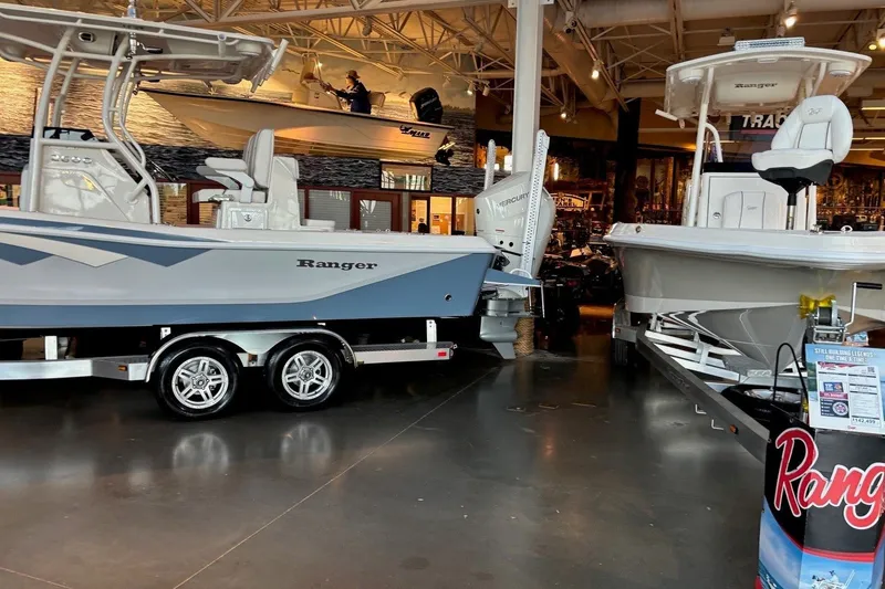 Slide: The Image of 2026 Ranger 2600 Bay boats displayed in a showroom with sleek design and modern features. - 8
