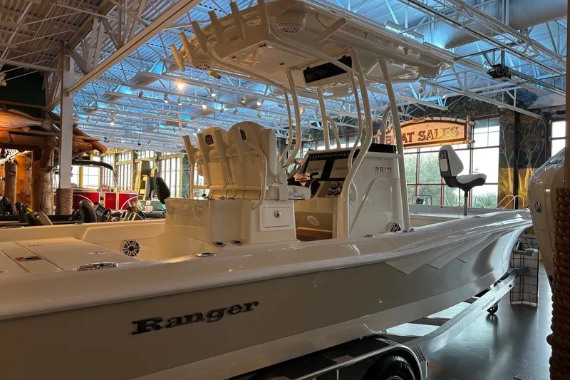 Slide: The Image of 2026 Ranger 2600 Bay boat displayed indoors, showcasing sleek design and modern features. - 12