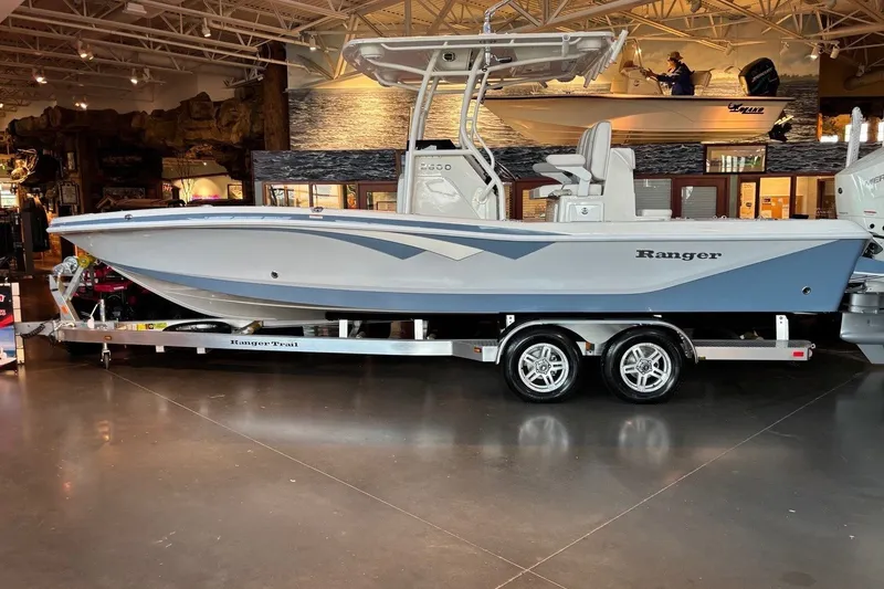 Slide: The Image of 2026 Ranger 2600 Bay boat on trailer in showroom, featuring sleek design and modern features. - 7