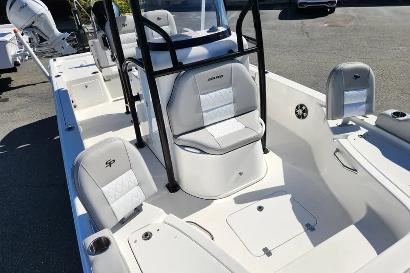 Slide: The Image of 2019 Sea Pro 248 Bay boat interior with white seating and console. - 10