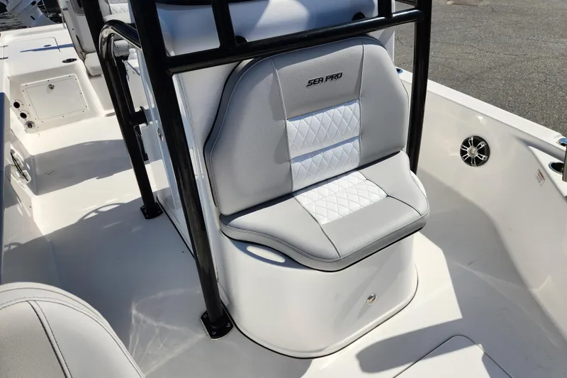 Slide: The Image of 2019 Sea Pro 248 Bay boat interior with cushioned seating and sleek design. - 13