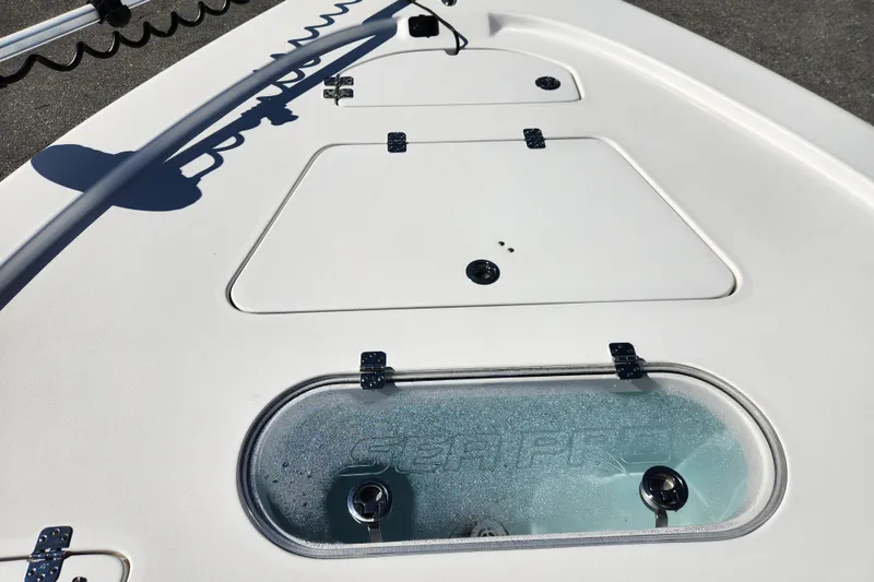 Slide: The Image of 2019 Sea Pro 248 Bay boat deck with storage compartments and livewell. - 14