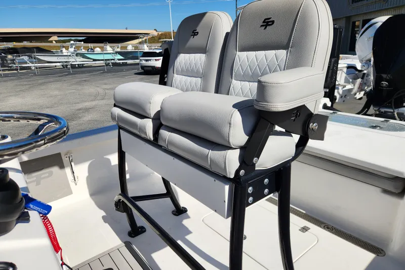 Slide: The Image of 2019 Sea Pro 248 Bay boat with dual cushioned seats and steering wheel. - 15