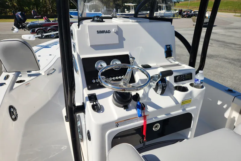 Slide: The Image of 2019 Sea Pro 248 Bay boat console with steering wheel and Simrad display. - 17