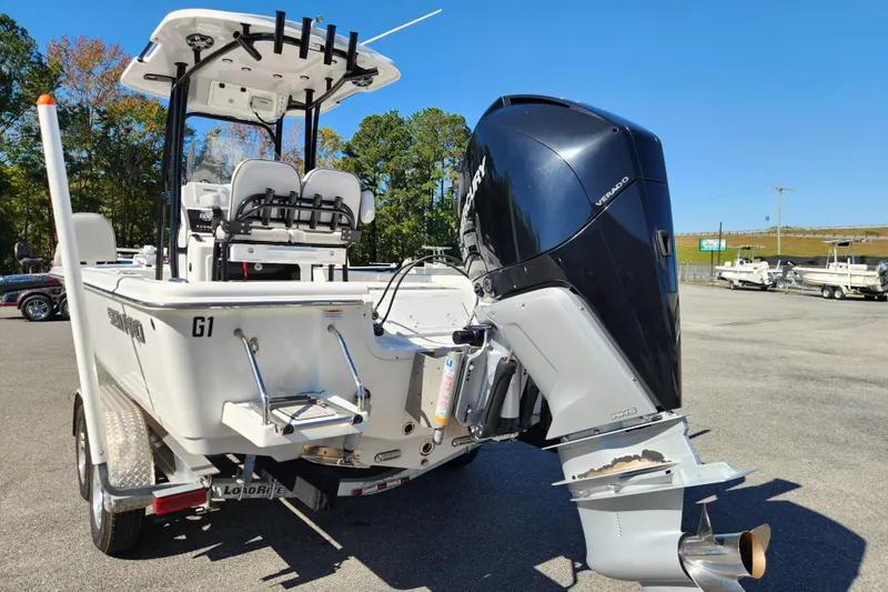 Slide: The Image of 2019 Sea Pro 248 Bay boat with powerful outboard motor, parked on a trailer. - 3