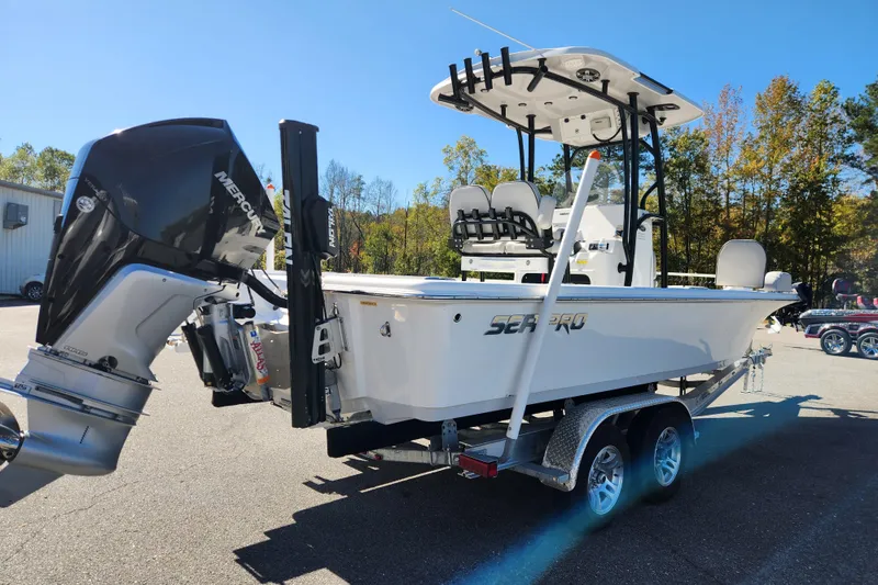 Slide: The Image of 2019 Sea Pro 248 Bay boat on trailer with Mercury engine, parked outdoors. - 5