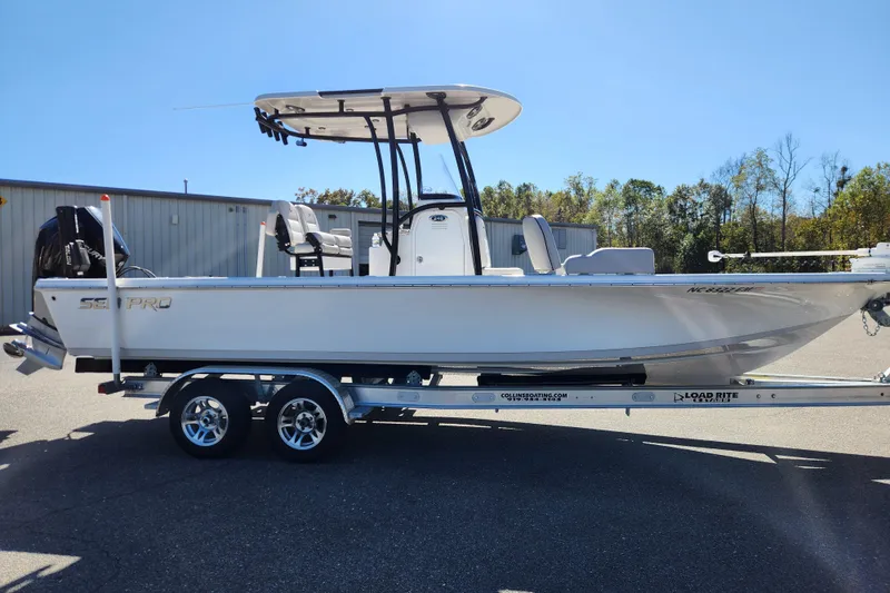 Slide: The Image of 2019 Sea Pro 248 Bay boat on trailer, parked outdoors, side view. - 6