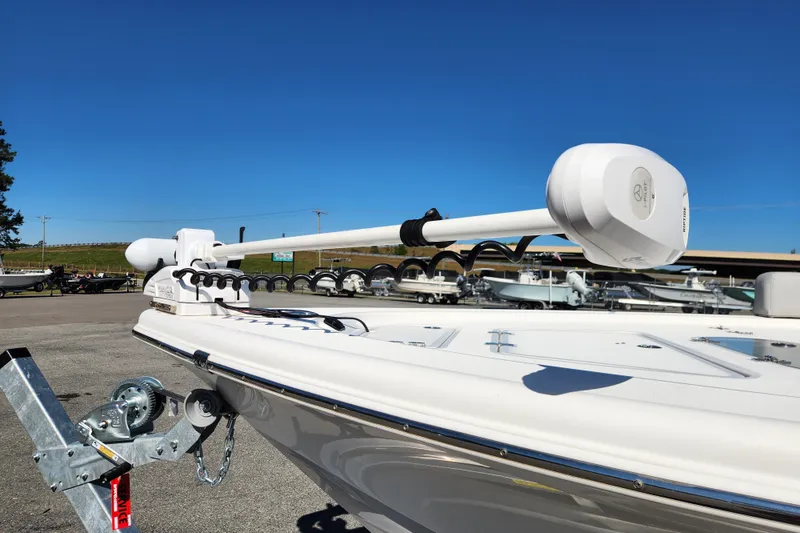 Slide: The Image of 2019 Sea Pro 248 Bay boat with trolling motor on trailer under clear blue sky. - 8