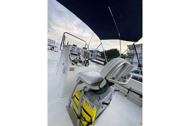 Slide: The Image of 2003 Sea Pro 206 Center Console boat interior with steering wheel and seating. - 7